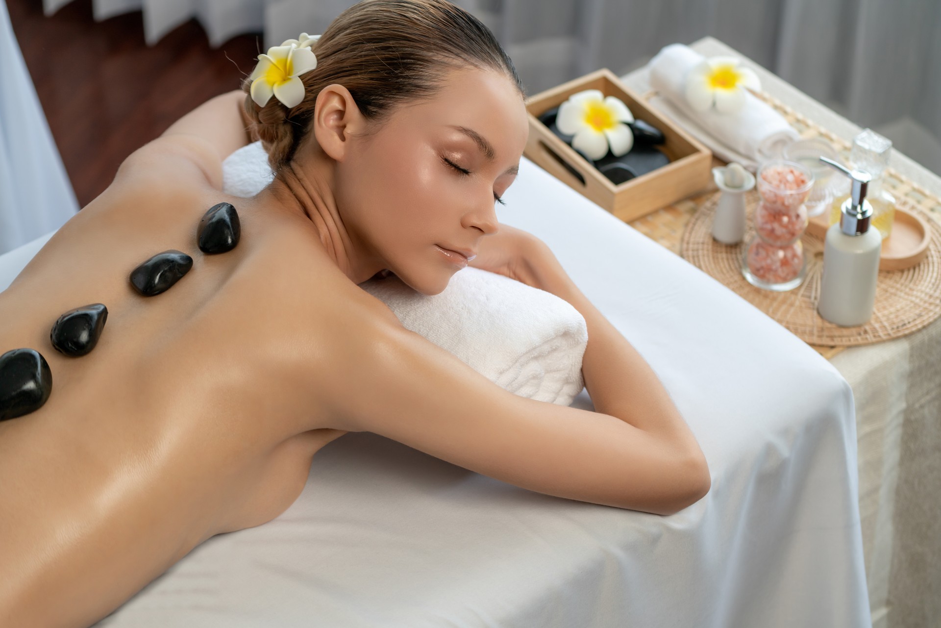 Hot stone massage at spa salon in luxury resort. Quiescent